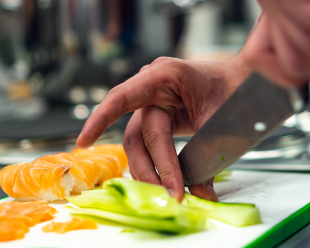 image of person cutting vegetables delicately using the tip of a knife